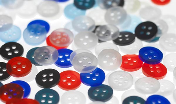 red, white, blue, and black shirt buttons on a white background