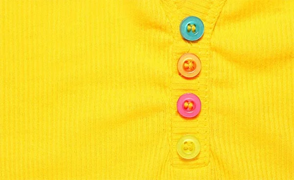 three buttons on a yellow polo shirt