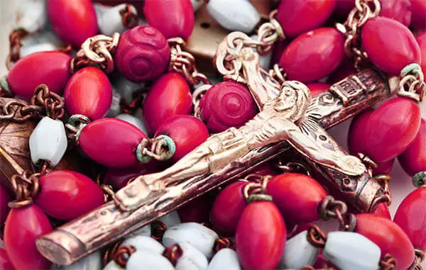 close up of a crucifix on a set of rosary beads