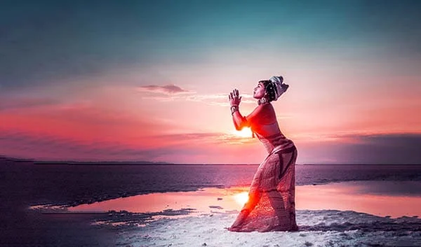 a photo of a woman posing in front of a sunset