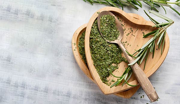 a love heart shaped bowl with rosemary in it 