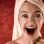 Woman waking from the dream of teeth falling out